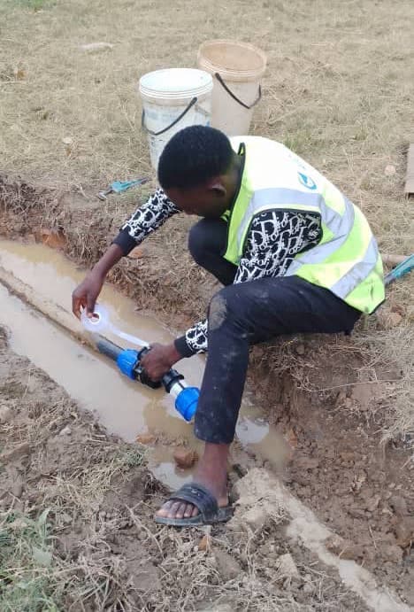 Paul fixing a pipe at Musapas Farm